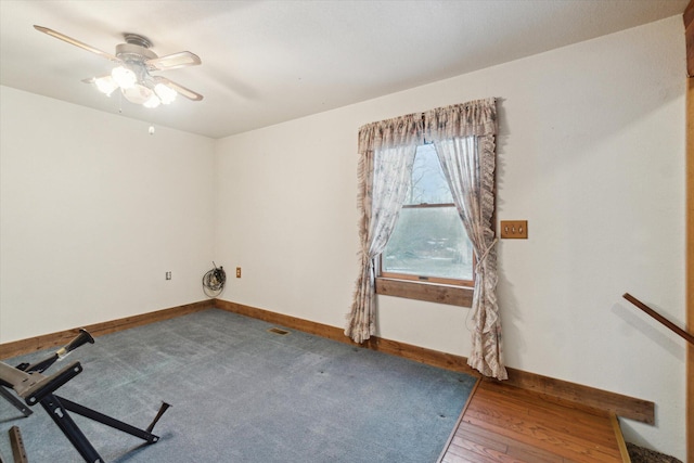 spare room featuring wood-type flooring and ceiling fan