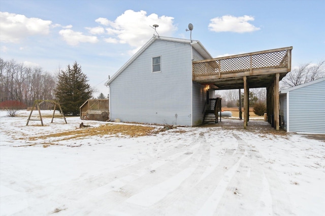 view of snow covered exterior featuring a wooden deck