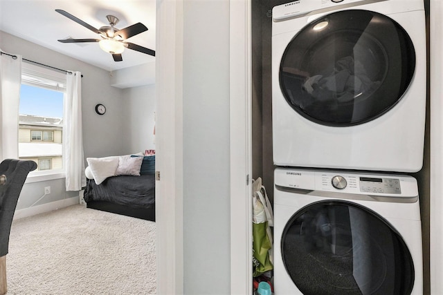 washroom with ceiling fan, stacked washer and dryer, and carpet