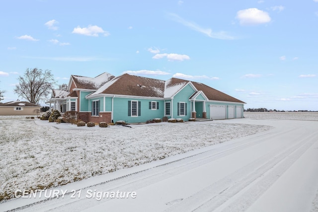 snow covered house with a garage