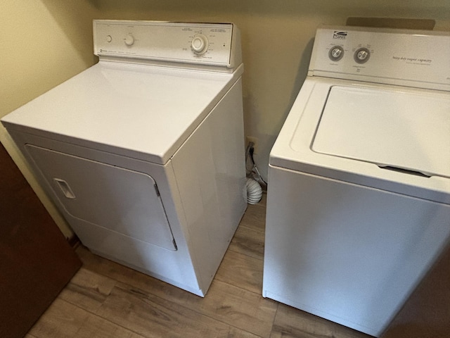 laundry area featuring hardwood / wood-style flooring and washer and clothes dryer