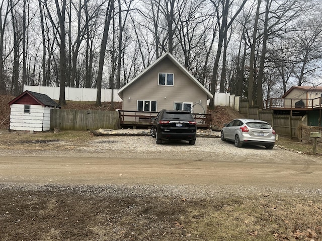 exterior space featuring a storage unit and a deck