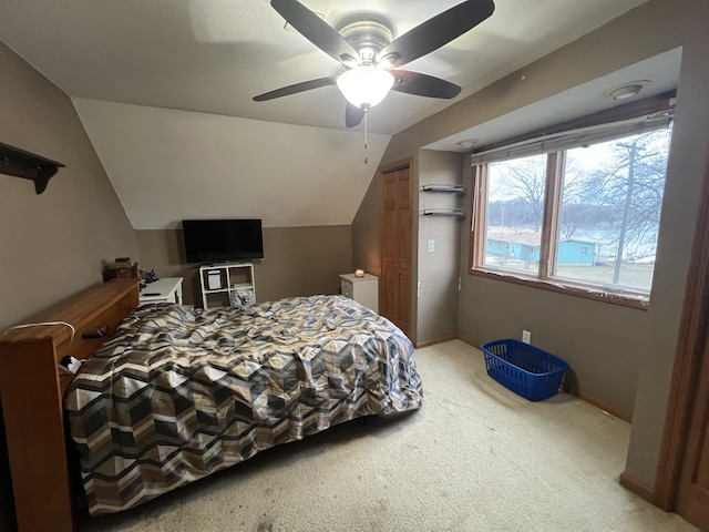 bedroom featuring lofted ceiling, light carpet, and ceiling fan