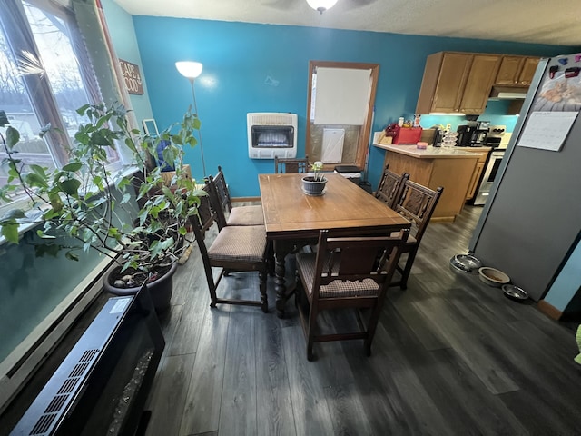 dining area featuring heating unit and dark hardwood / wood-style floors