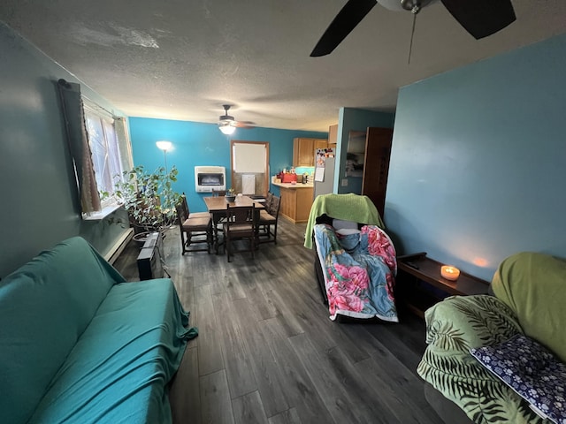 living room with ceiling fan, wood-type flooring, and a textured ceiling