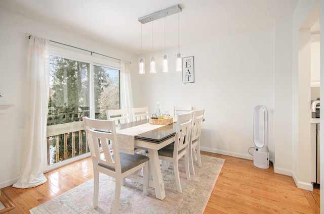 dining space featuring light wood-type flooring