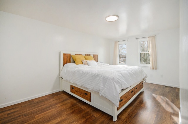 bedroom with dark wood-type flooring