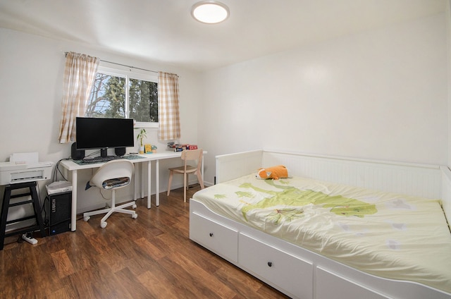 bedroom with dark hardwood / wood-style floors