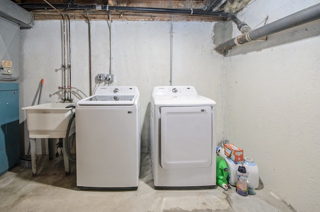 clothes washing area featuring sink and independent washer and dryer