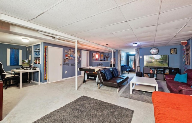 carpeted living room with a drop ceiling