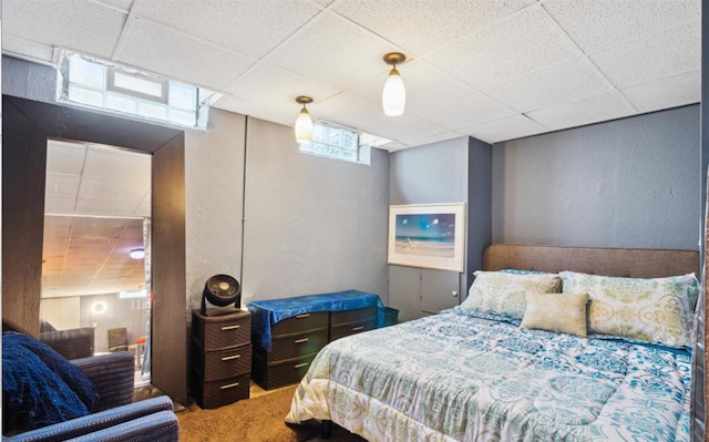 carpeted bedroom with a paneled ceiling