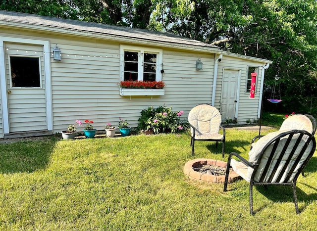 exterior space featuring a yard and an outdoor fire pit