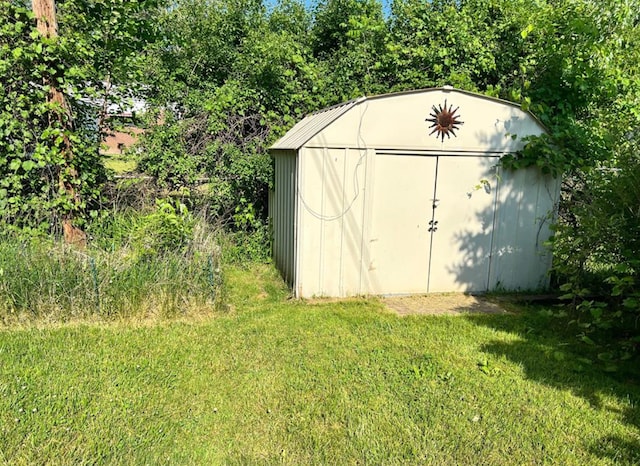 view of outbuilding featuring a lawn