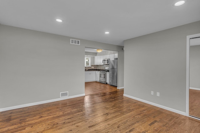 unfurnished living room featuring wood-type flooring