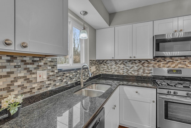 kitchen with white cabinetry, sink, dark stone counters, and appliances with stainless steel finishes