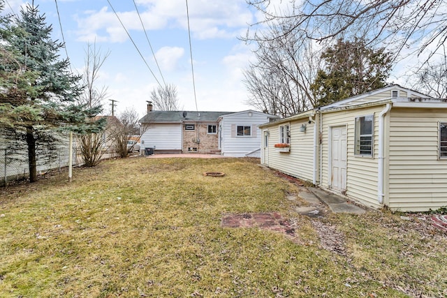 rear view of property featuring a yard