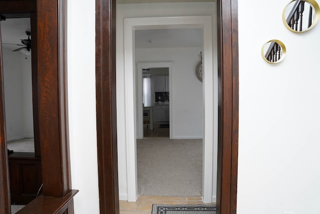 hall featuring light colored carpet