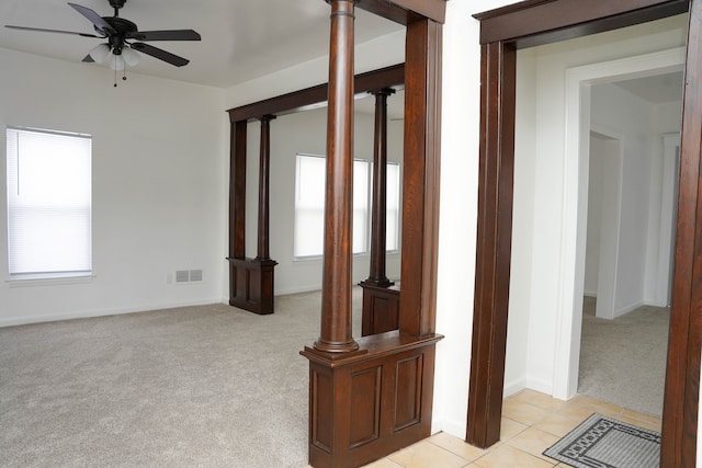 unfurnished living room featuring light carpet and ceiling fan