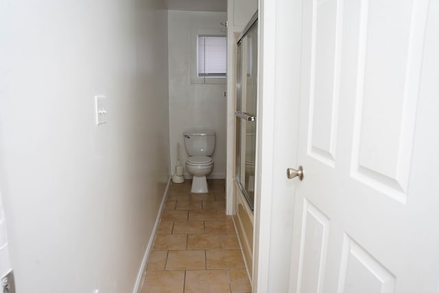 bathroom with tile patterned floors and toilet