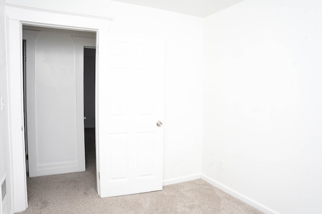 unfurnished bedroom with light carpet