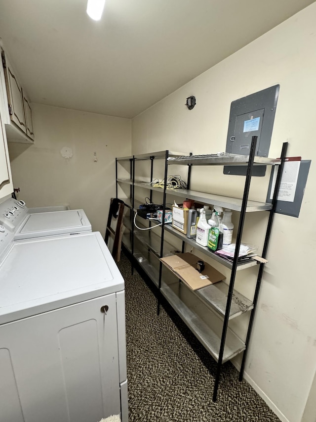 washroom with dark colored carpet, cabinets, and washing machine and clothes dryer