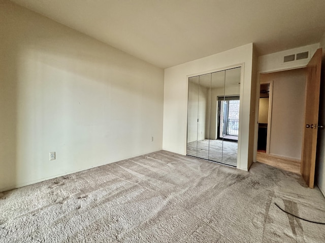 unfurnished bedroom with carpet floors and a closet