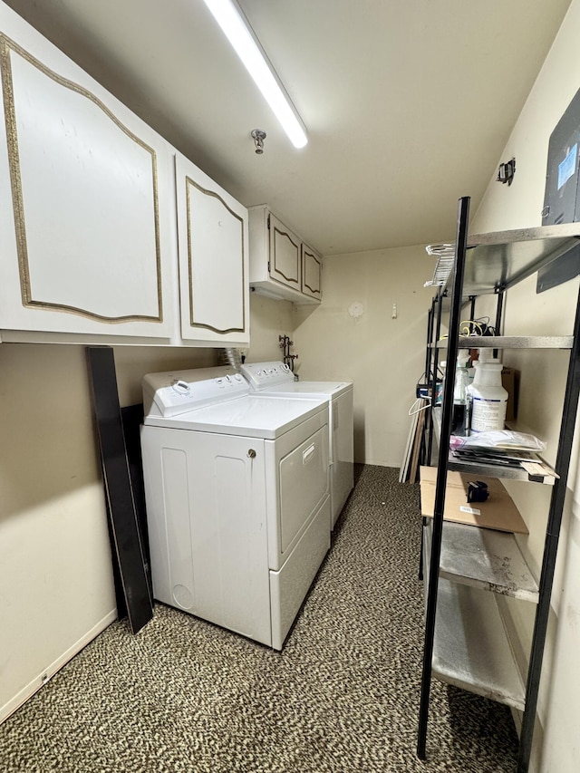 laundry area featuring separate washer and dryer and cabinets