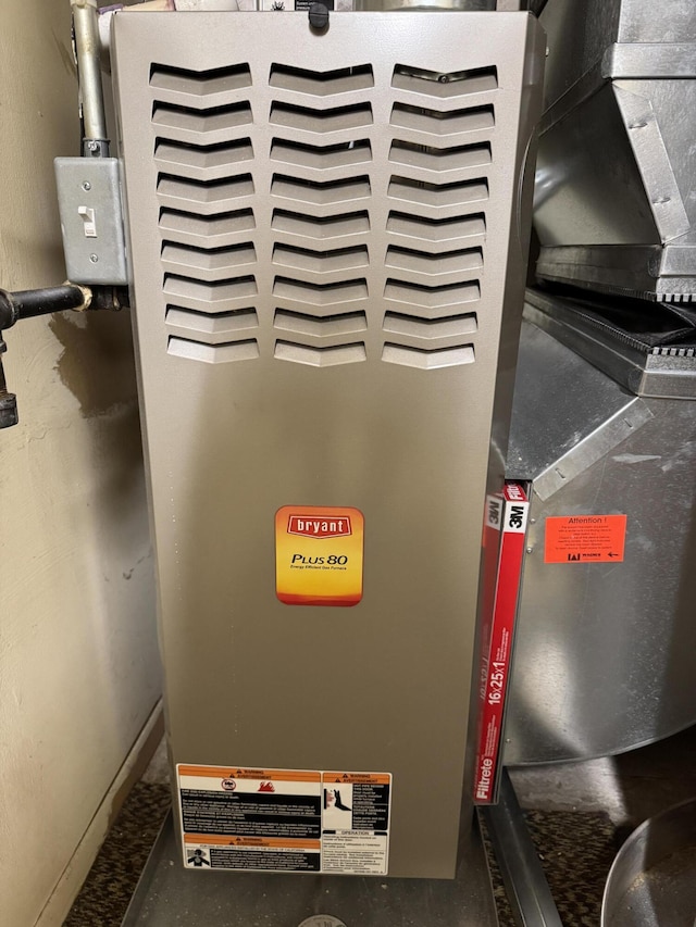 utility room featuring heating unit