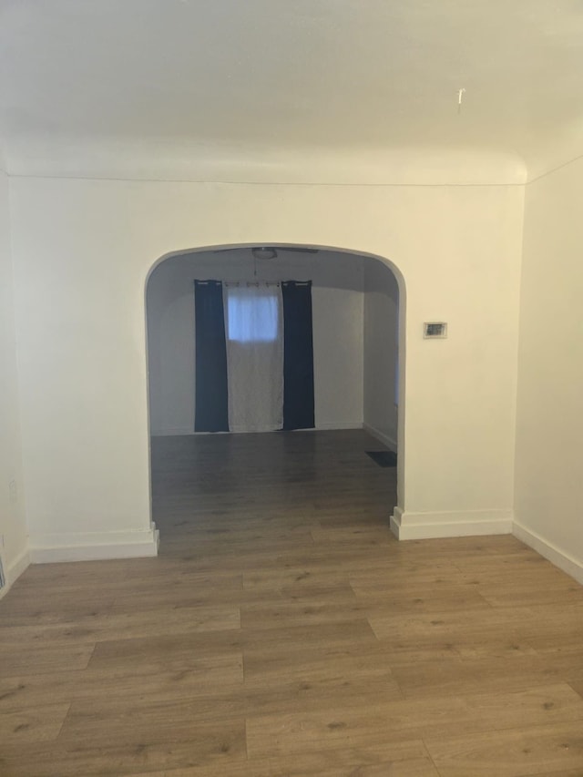 hallway with hardwood / wood-style floors