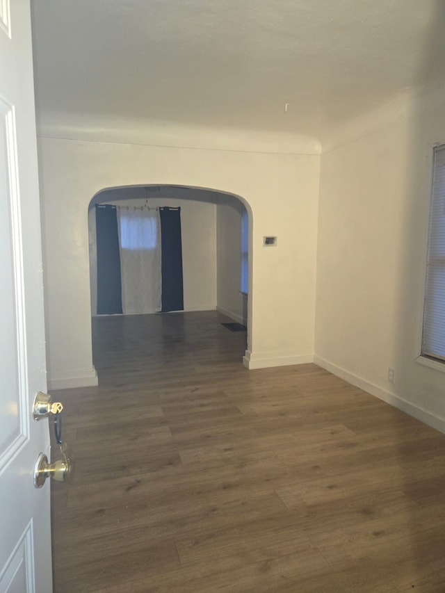 unfurnished room featuring dark hardwood / wood-style floors