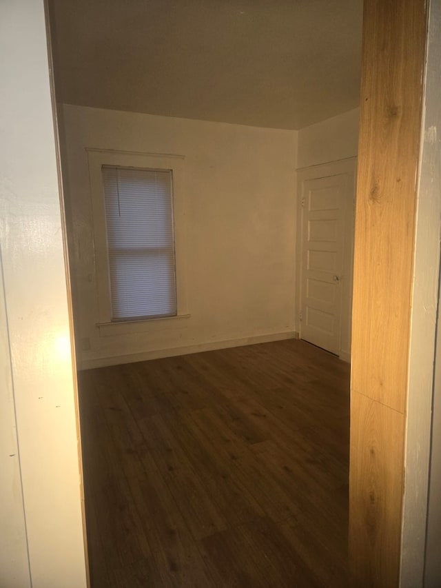 empty room featuring dark hardwood / wood-style flooring