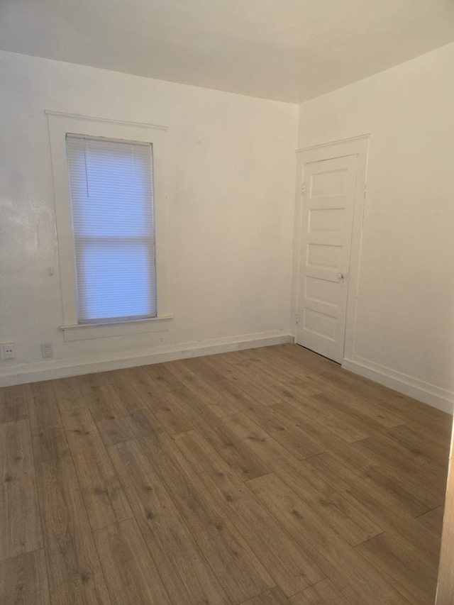 unfurnished room featuring hardwood / wood-style flooring