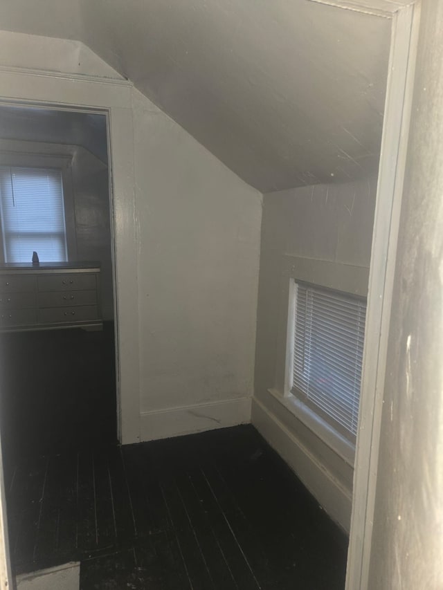 bonus room featuring dark hardwood / wood-style flooring and vaulted ceiling