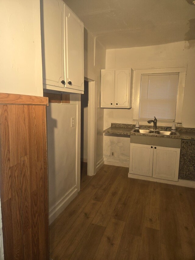 kitchen with sink, dark wood-type flooring, and white cabinets