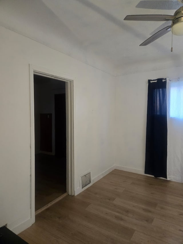 empty room featuring ceiling fan and hardwood / wood-style floors