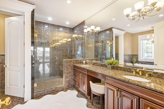 bathroom with an inviting chandelier, vanity, and plus walk in shower