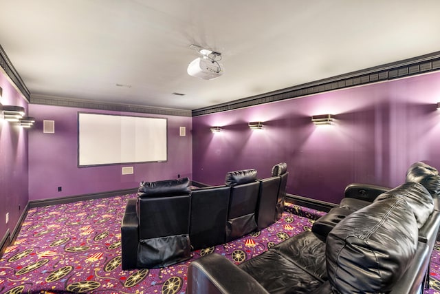 carpeted home theater with ornamental molding