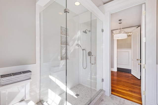 bathroom featuring hardwood / wood-style floors and a shower with shower door