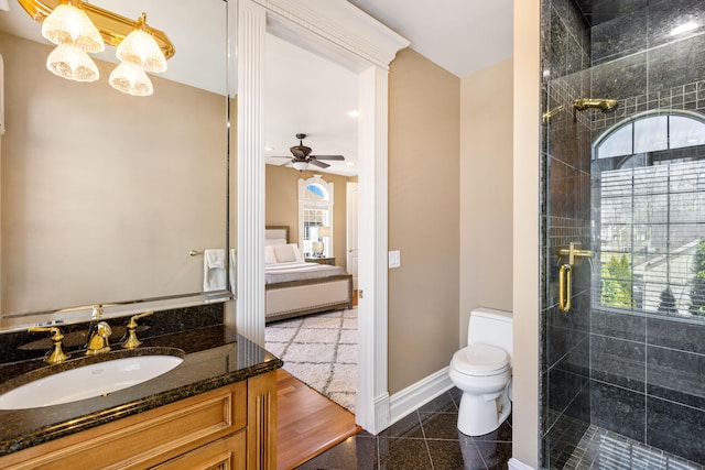 bathroom featuring vanity, ceiling fan with notable chandelier, toilet, and a shower with shower door