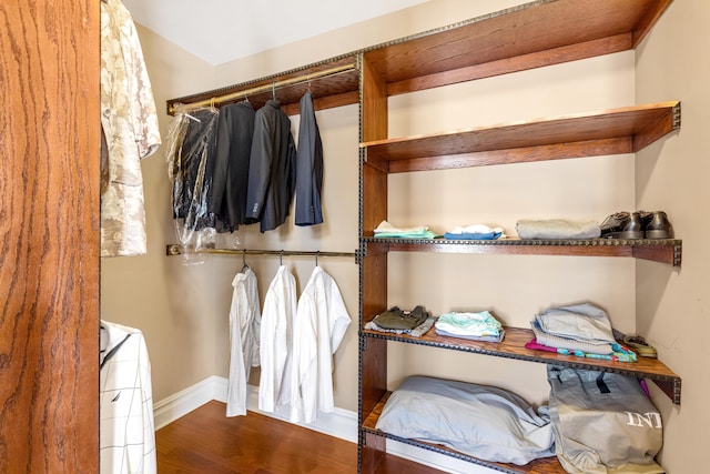 walk in closet with hardwood / wood-style floors