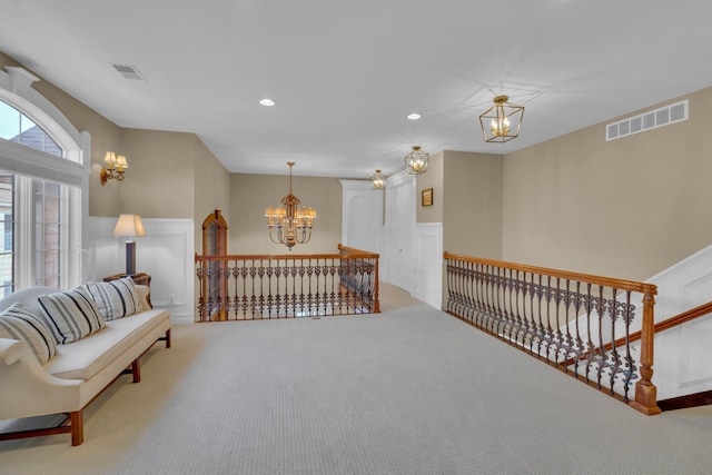 living area featuring an inviting chandelier and carpet floors