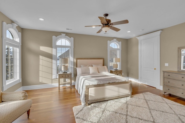 bedroom with hardwood / wood-style floors and ceiling fan