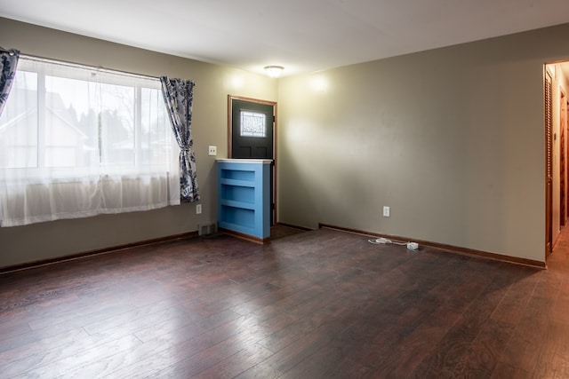 empty room with dark wood-type flooring