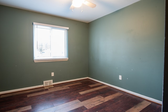 unfurnished room featuring dark hardwood / wood-style floors and ceiling fan