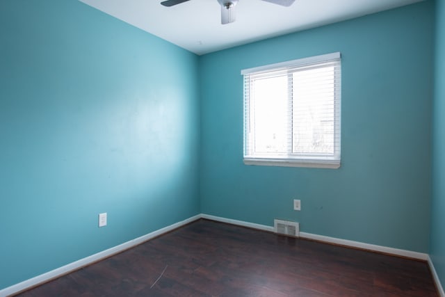 unfurnished room featuring ceiling fan and dark hardwood / wood-style flooring