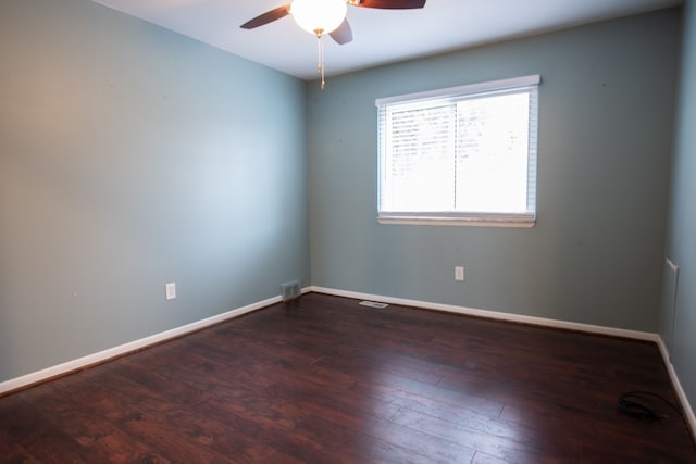 unfurnished room with dark hardwood / wood-style floors and ceiling fan