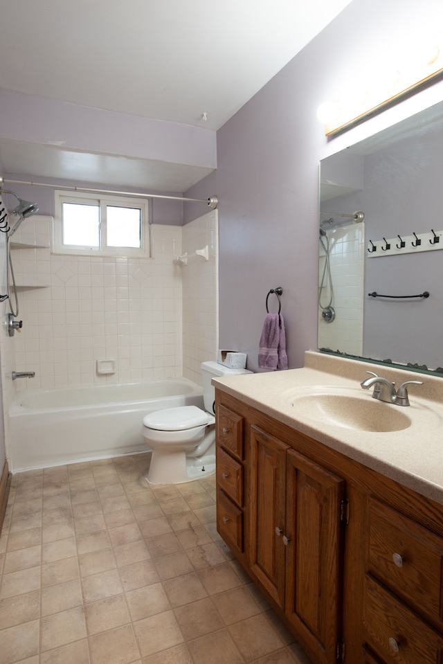 full bathroom featuring tiled shower / bath combo, vanity, and toilet