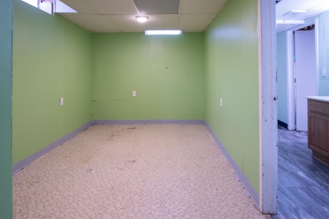 basement featuring a paneled ceiling