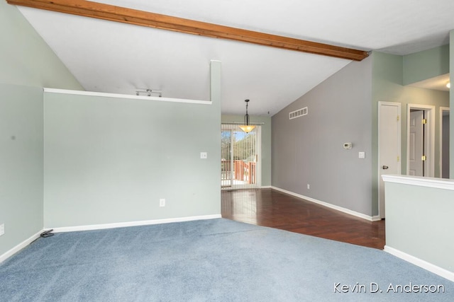 spare room with visible vents, track lighting, vaulted ceiling with beams, baseboards, and carpet floors