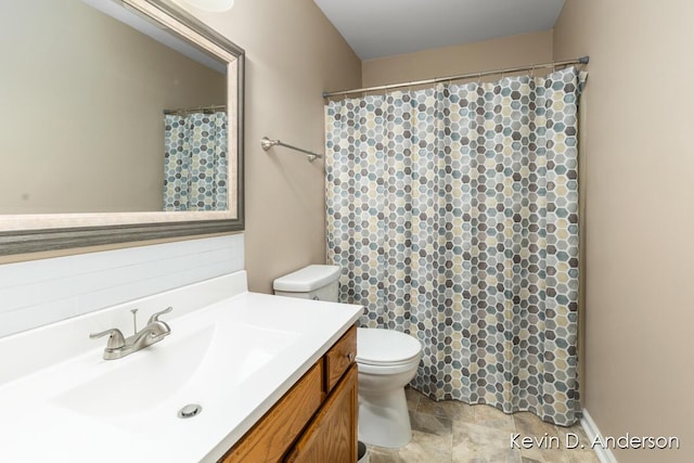 bathroom featuring curtained shower, toilet, and vanity